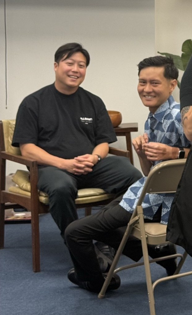 Two participants seated and laughing during an exercise